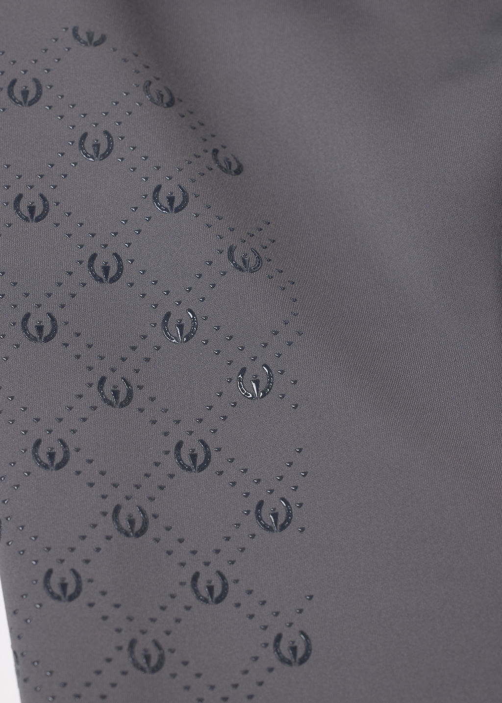 Closeup view of the Carbon Kerrits Free Motion Coolcore Knee Patch Breech showing the silicone grip