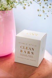 Angled front view of the packaging for the Clean Barn Stable Style Soy Wax Candle