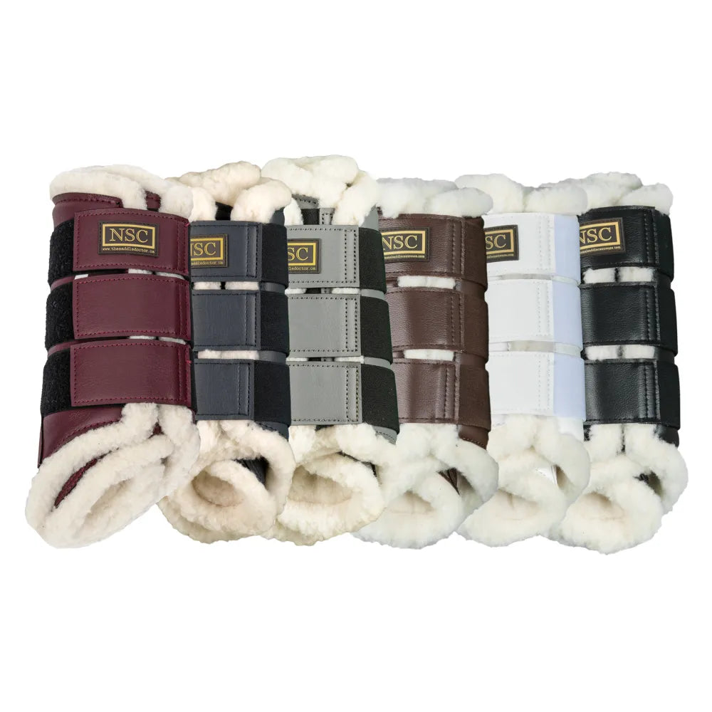 View of an assortment of colors of the NSC Fleece-Lined Brushing Boots on a white background