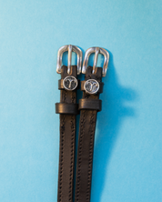 View of the Aries Mane Jane Spur Straps on a blue background