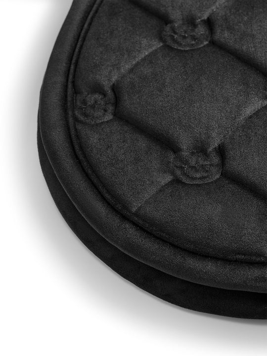Close-up view of the edge of the Black Equestrian Stockholm Velvet Jump Saddle Pad on a white background