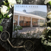 Front view of the Stable Style Book-Volume III on a marble and flower background