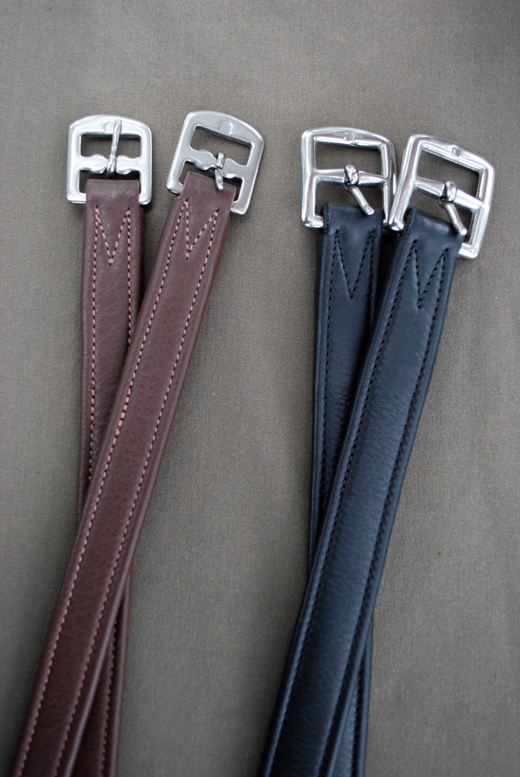 Side-by-side views of a pair of brown and a pair of black Red Barn Calf Lined Leathers on a gray background