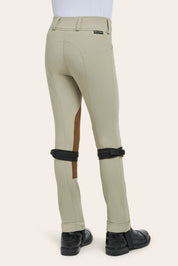 Beige riding pants with brown patch and black knee pads on a white background