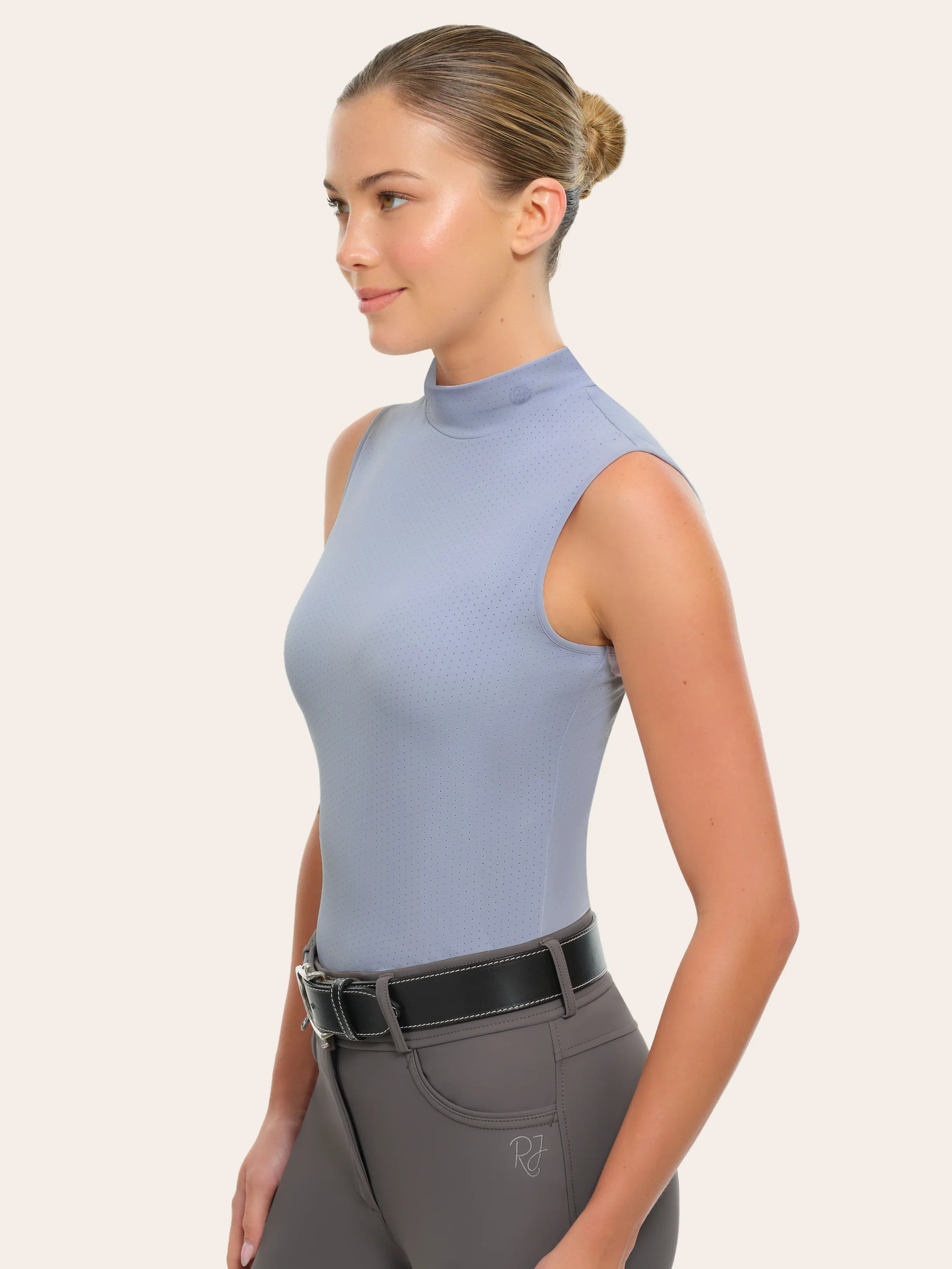 Side view of a female model wearing the blue RJ Classics Corrie Mock Neck Shirt on a white background