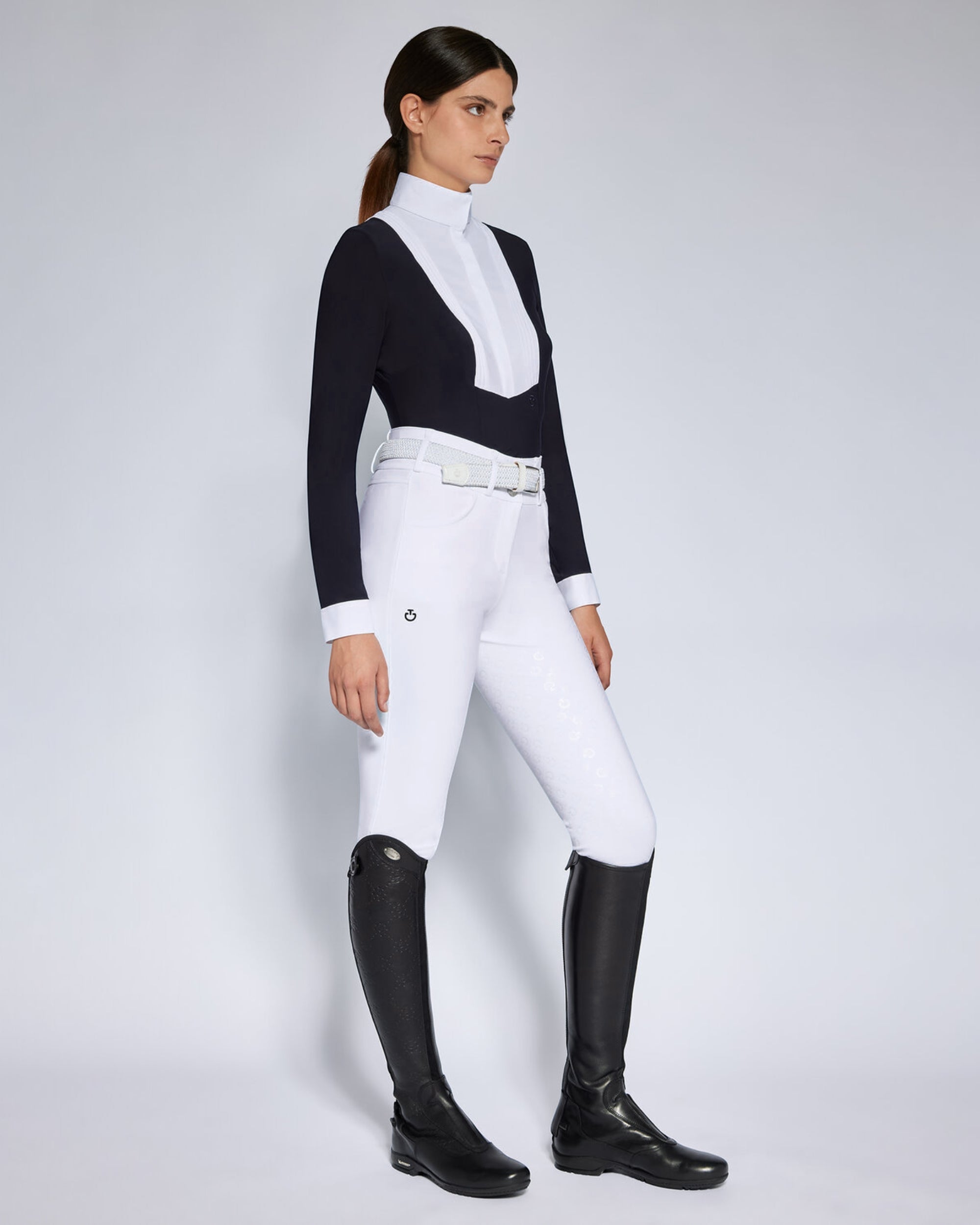 Angled front view of a female model wearing the Black Cavalleria Toscana American Long Sleeve Competition Shirt on a plain background