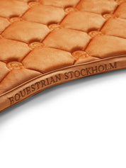 Close-up view of the spine on the Chestnut Equestrian Stockholm Velvet Jump Saddle Pad on a plain background
