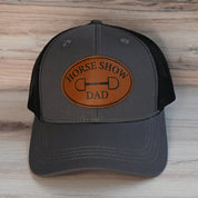 Front view of the Horse Show Dad Dubois Cheval Baseball Hat on a wood background