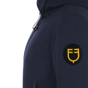 Close-up view of the Equestro logo on the sleeve of the Navy Blazer Equestro Water & Wind Repellent Down Jacket on a plain background