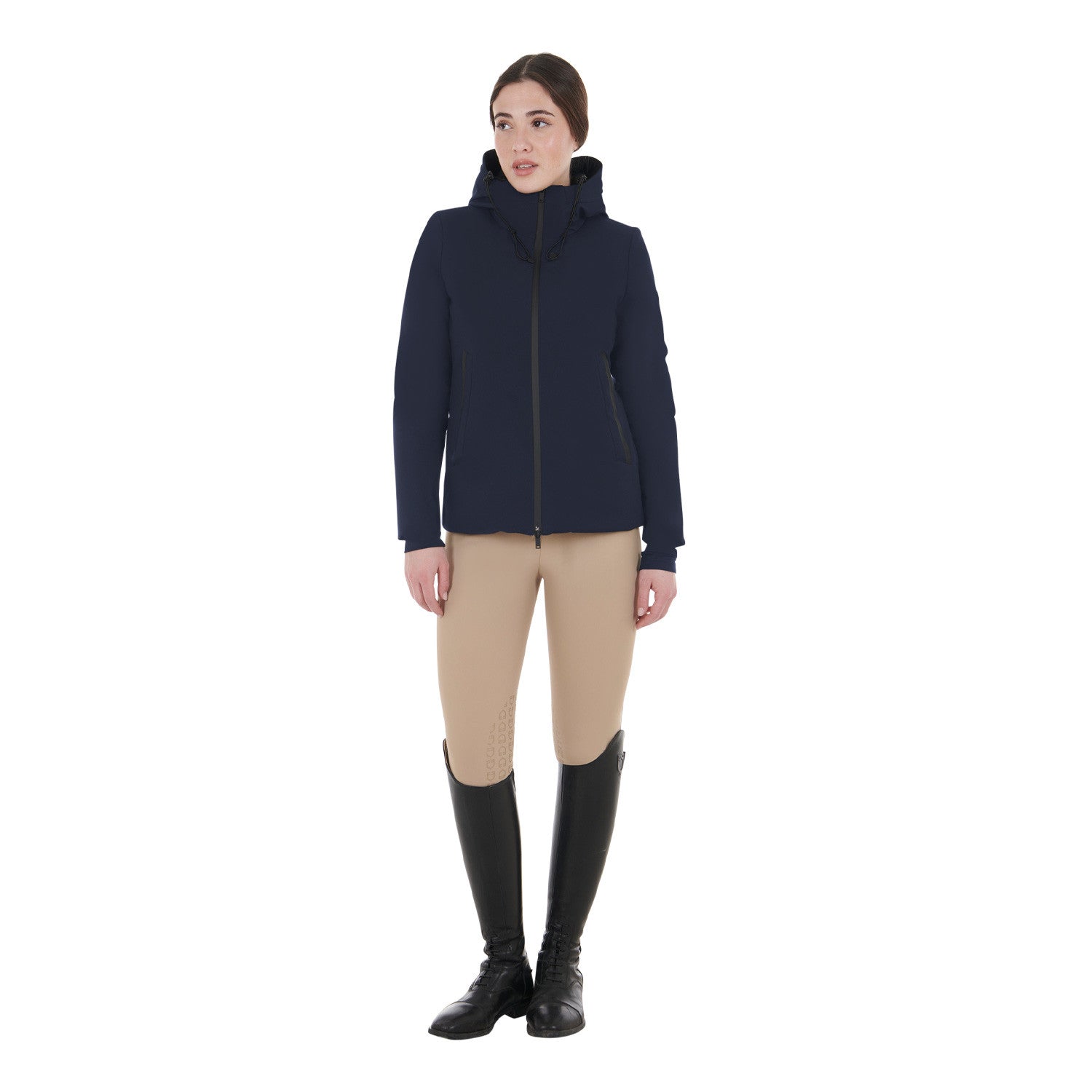 Full body front view of a female model wearing the Navy Blazer Equestro Water & Wind Repellent Down Jacket with tan breeches on a plain background