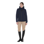 Full body front view of a female model wearing the Navy Blazer Equestro Water & Wind Repellent Down Jacket with tan breeches on a plain background