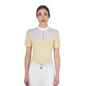 Front view of model wearing the Equestro Women's Slim Fit Competition Polo Shirt With Silk-Like Fabric Inserts in white and yellow on a white background