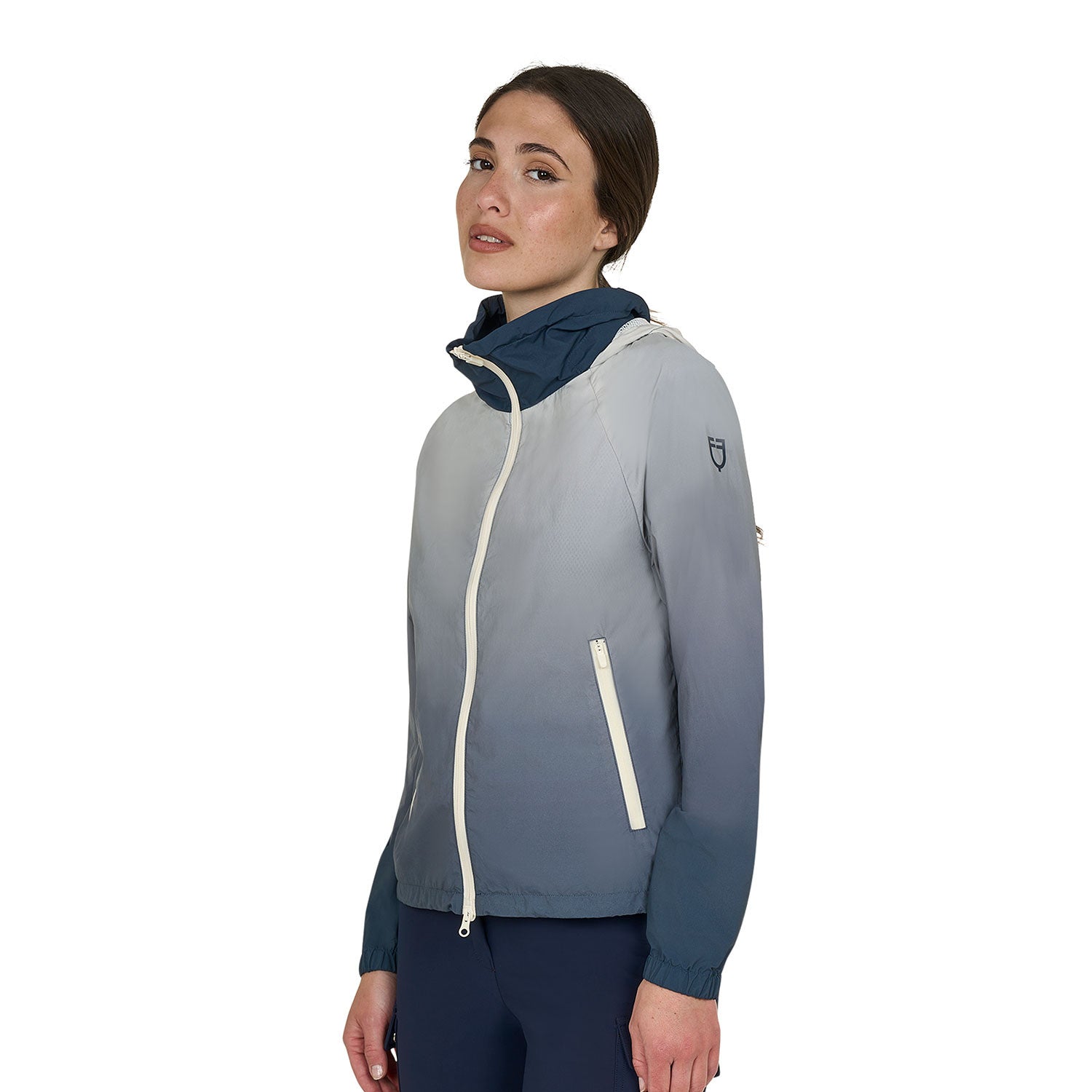 Angled front view of model wearing the Equestro Women's Water-Repellent Outerwear in ombre navy and white on a white background