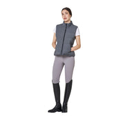 Full body front view of a female model wearing the Grey Melange Equestro Quilted Wool Vest with gray breeches on a plain background