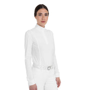 Angled front view of a female model wearing the White Equestro Perforated Long-Sleeve Competition Polo Shirt on a plain background