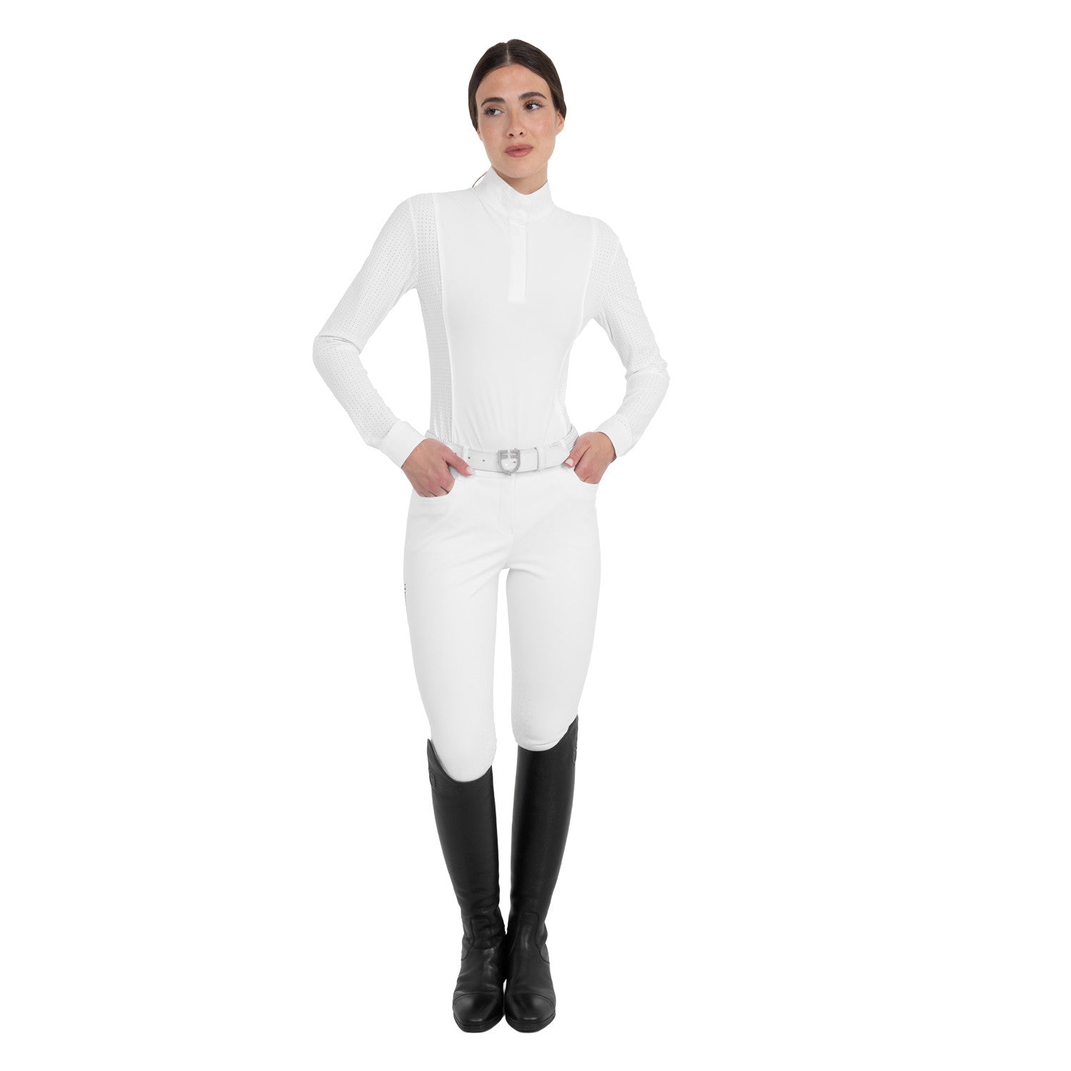 Full body front view of a female model wearing the White Equestro Perforated Long-Sleeve Competition Polo Shirt with white breeches on a plain background