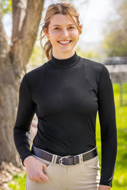 Front view of a model wearing the Kastel Black Perforated Long Sleeve Mock Neck Performance Shirt outdoors