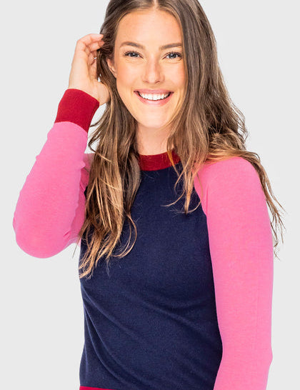 Front view of a female model wearing the navy, hot pink, and wine Kastel Crewneck Sweater on a plain background