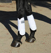 View of black horse wearing a pair of White Professional's Choice Performance Elite Cross Country Front Boots while standing in the dirt