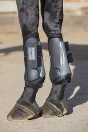 Side view of a black horse wearing the Black Hook & Loop Professional's Choice Pro Performance Open Front Boots while standing on sand