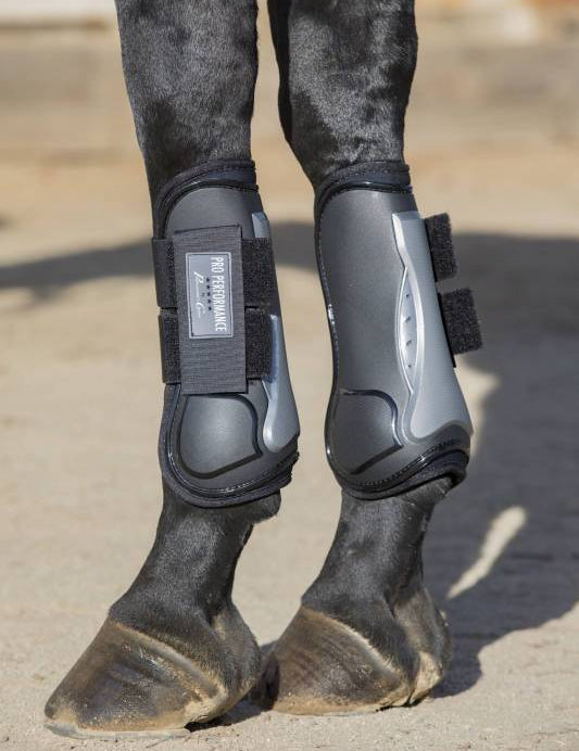 Side view of a black horse wearing the Black Hook & Loop Professional's Choice Pro Performance Open Front Boots while standing on sand