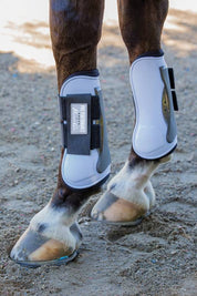 Side view of a horse wearing the White Hook & Loop Professional's Choice Pro Performance Open Front Boots while standing on sand