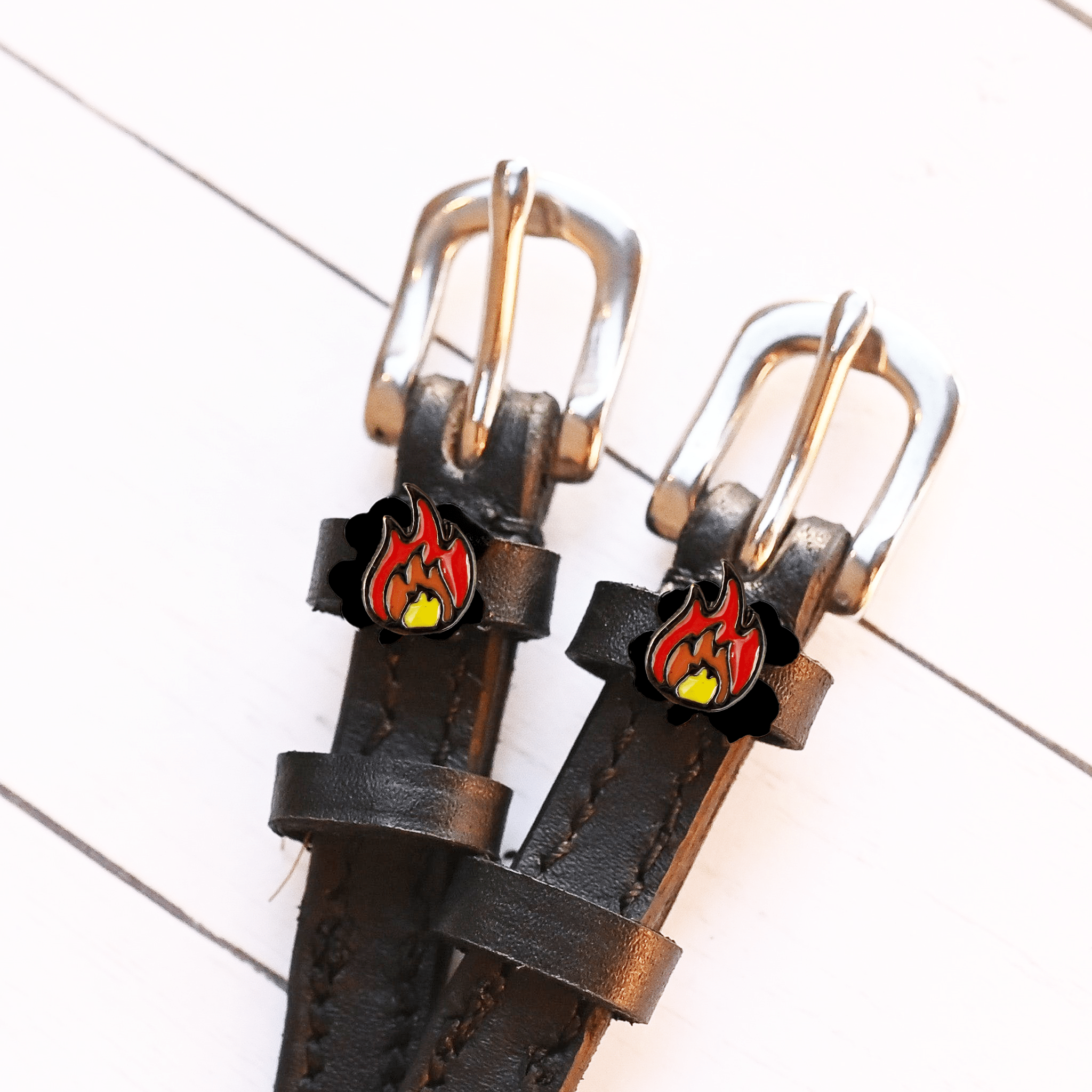 View of the Flame Mane Jane Spur Straps  on a white shiplap background