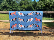 View of the Fancy Horses Mare Modern Goods Blanket draped over a raw wood fence outside