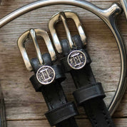 View of the Gemini Mane Jane Spur Straps on a wood background