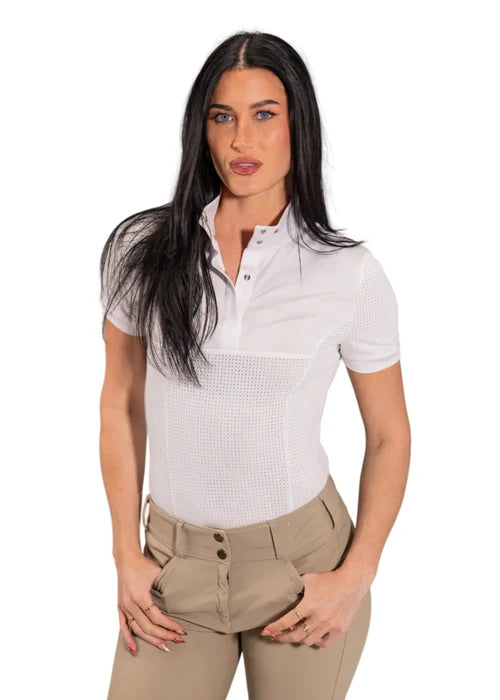 Woman wearing a white short-sleeve shirt with a patterned design and beige pants on a white background