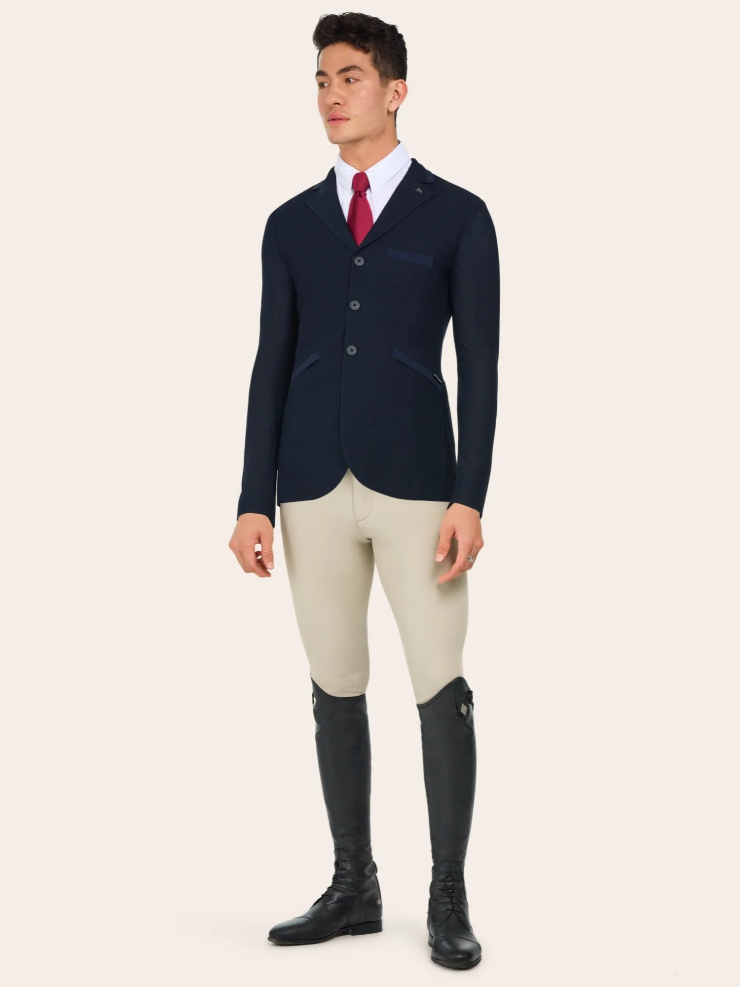 Full body front view of a male model wearing the Navy RJ Classics Hudson Men's Mesh Coat with tan breeches on a plain background