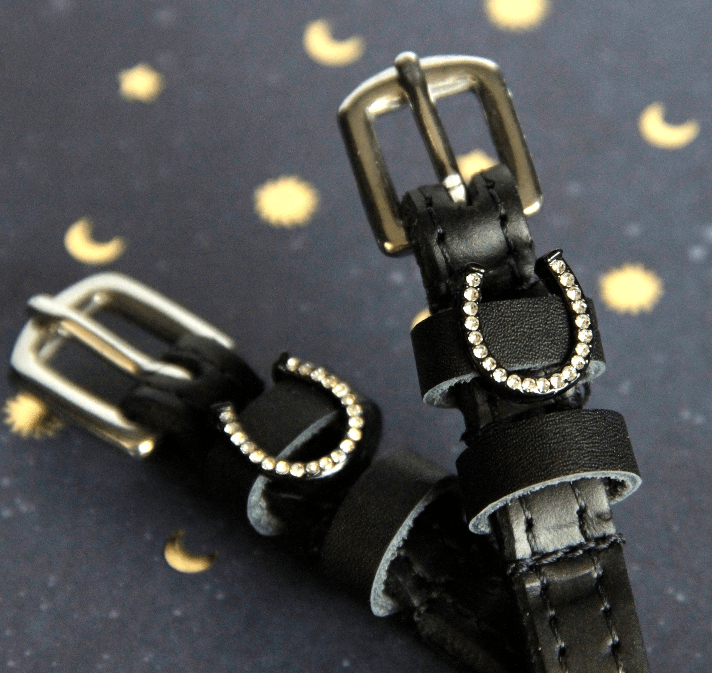 View of the Sparkly horse show Mane Jane Spur Straps  on a moon and star background