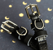 View of the Sparkly horse show Mane Jane Spur Straps  on a moon and star background