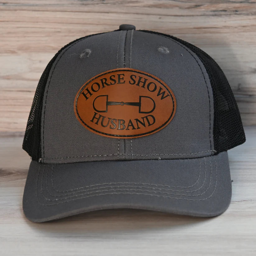 Front view of the Horse Show Husband Dubois Cheval Baseball Hat on a wood background