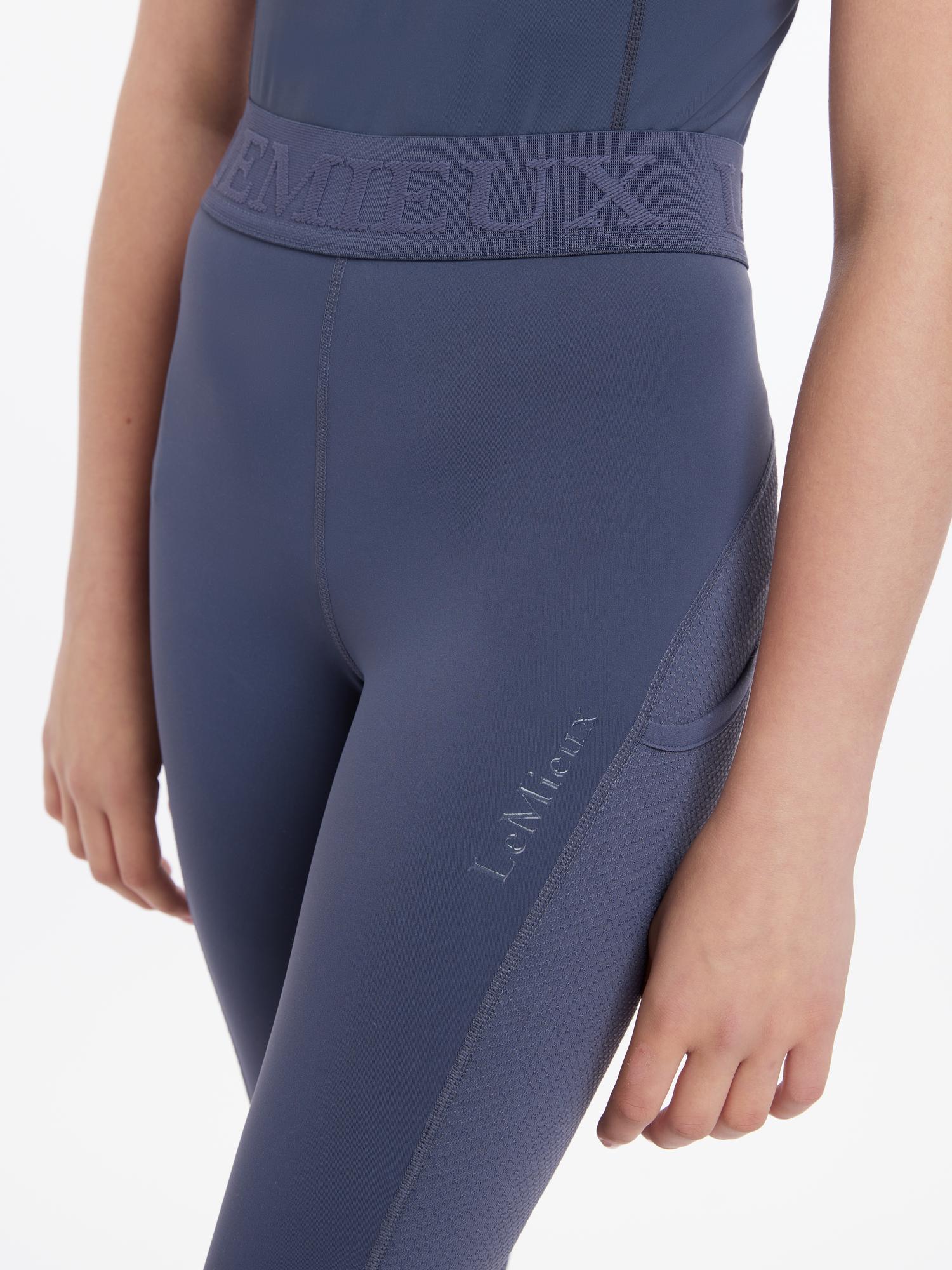 Close-up front view of a young female model wearing the Dusk LeMieux Young Rider Lizzie Mesh Legging on a plain background