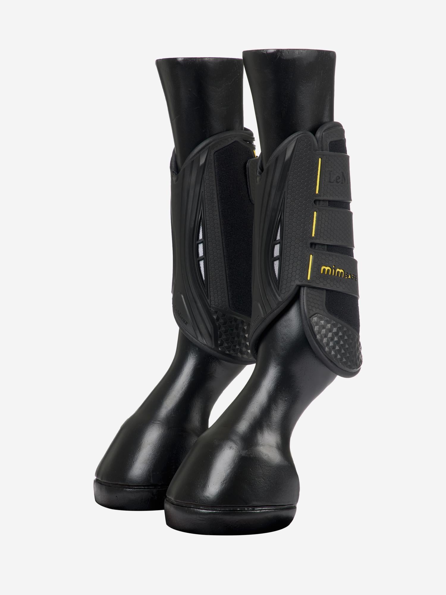 Side view of a pair of LeMieux MIMsafe XC Front Boots on horse mannequin legs on a plain background