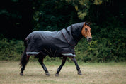 Side view of a horse wearing the Black LeMieux Arika Storm-Tek 350G Rug while trotting in a pasture
