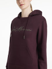 Close-up front view of a female model wearing the Damson LeMieux Elspeth Hoodie on a plain background