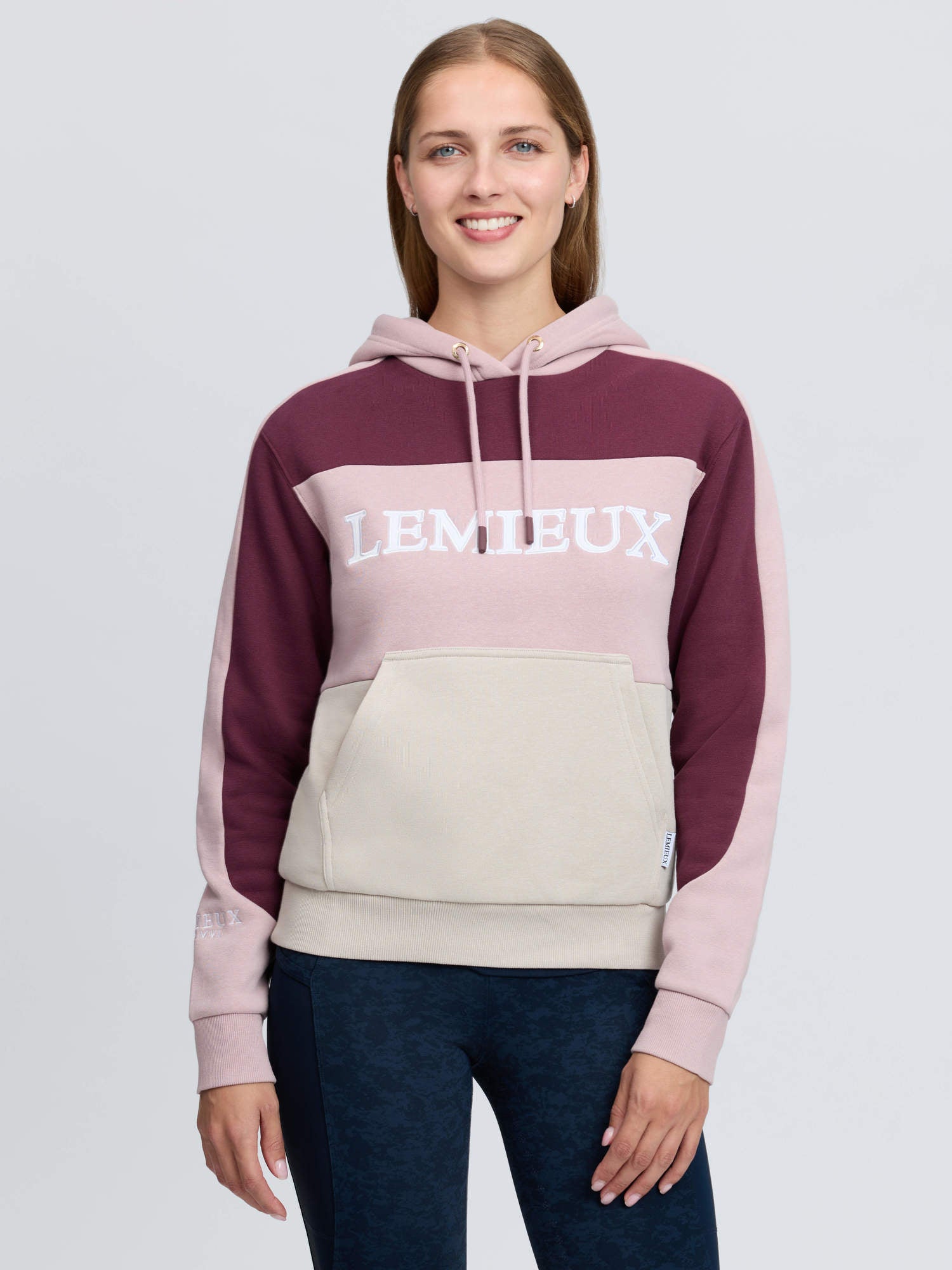 Front view of a model wearing the Wild Rose LeMieux Kadie Color Block Hoodie on a plain background