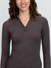 Front view of a female model wearing the Cocoa LeMieux Heritage Check Long Sleeve Base Layer on a plain background