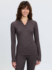 Front view of a female model wearing the Cocoa LeMieux Heritage Check Long Sleeve Base Layer on a plain background