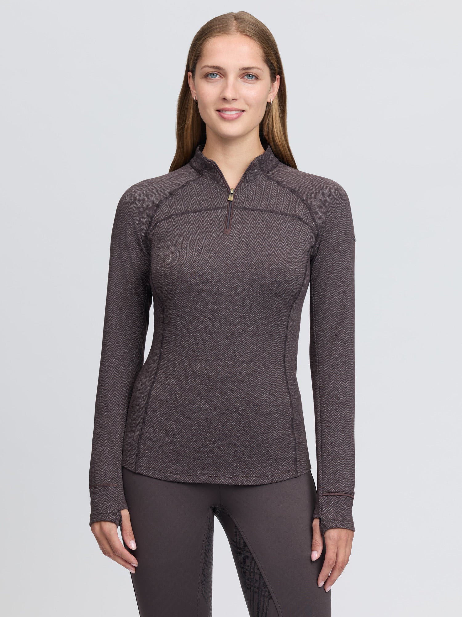 Front view of a female model wearing the Cocoa LeMieux Heritage Herringbone Base Layer on a plain background
