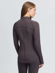 Back view of a female model wearing the Cocoa LeMieux Heritage Herringbone Base Layer on a plain background