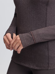 Close-up view of the sleeve cuffs on the Cocoa LeMieux Heritage Herringbone Base Layer on a plain background