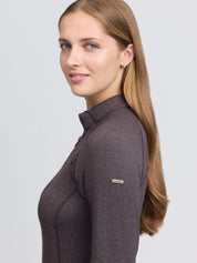 Side view of a female model wearing the Cocoa LeMieux Heritage Herringbone Base Layer on a plain background