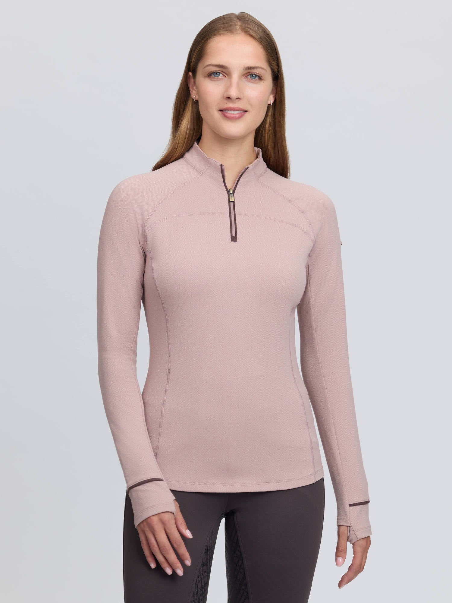 Front view of a female model wearing the Wild Rose LeMieux Heritage Herringbone Base Layer on a plain background