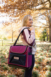 View of a female model holding the Blackberry Elite Pro Grooming Bag over her shoulder outside