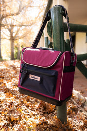 Front view of the Blackberry Elite Pro Grooming Bag hanging on a fence post outside