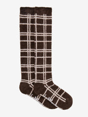 Side view of a pair of Cocoa LeMieux Heritage Check Fluffies on a plain background