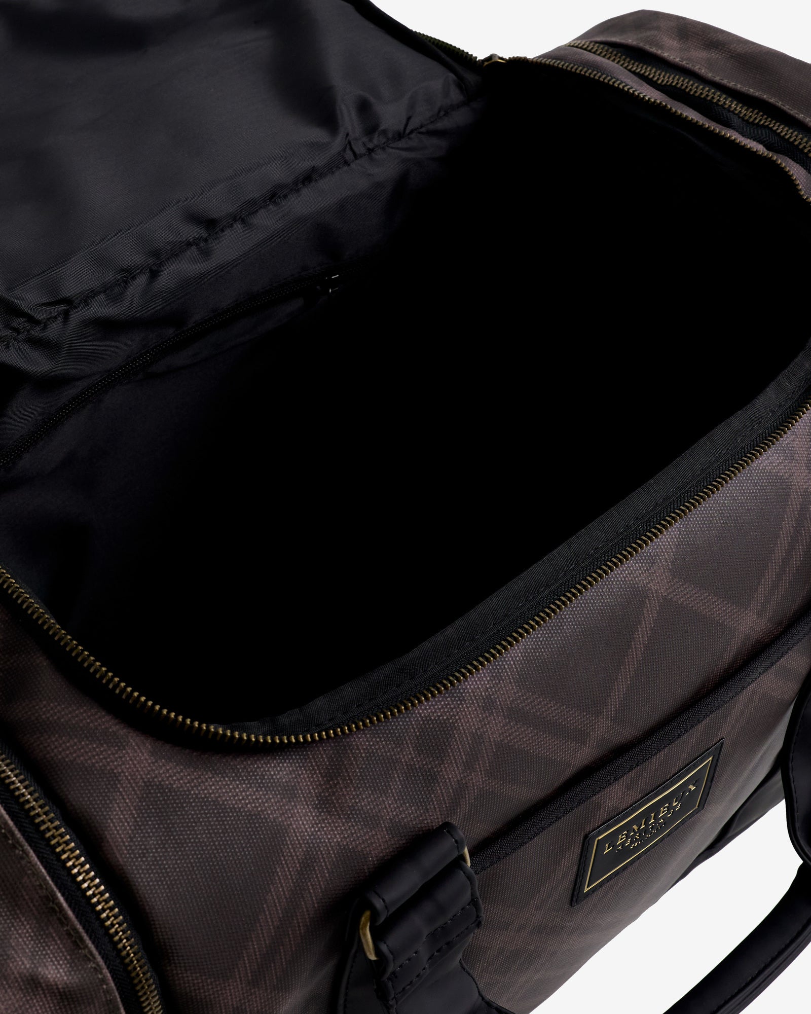 Close-up view of the interior of the Cocoa LeMieux Heritage ProKit Lite Grooming Bag on a plain background